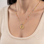 Close-up of Koda engraving on the gold Rainbow Bridge necklace