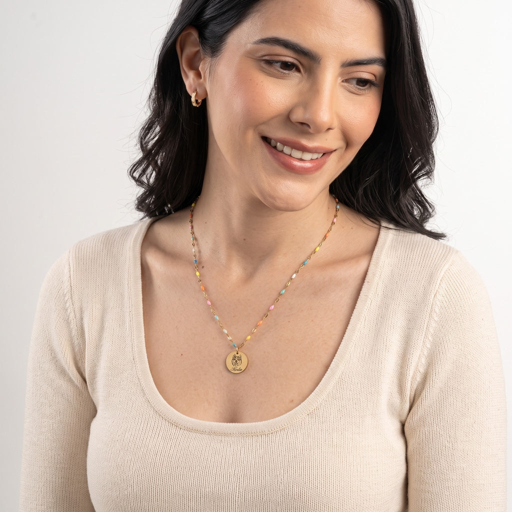 Gold Rainbow Bridge necklace with Koda engraving, being worn
