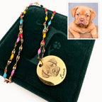 Rainbow Bridge necklace with Luna engraving on dark-green gift box against cream background